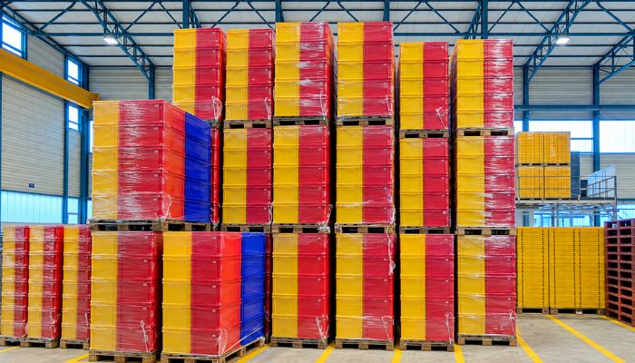 Plastic bins stacked and packaged for transportation